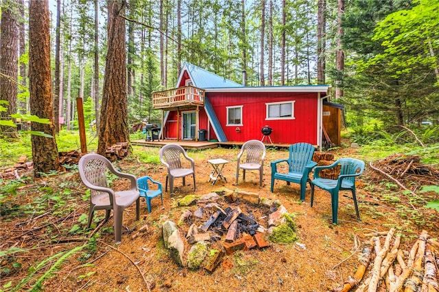 view of yard featuring a wooden deck and a fire pit