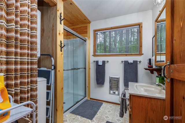 bathroom featuring an enclosed shower, tile flooring, and large vanity