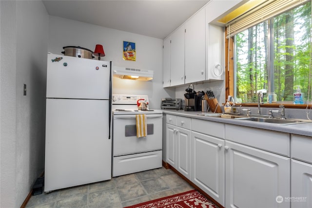 kitchen featuring sink, white cabinets, white appliances, and light tile floors