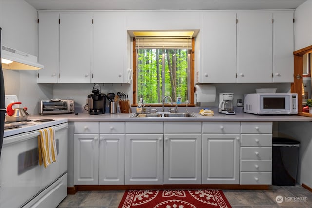 kitchen with white appliances and white cabinetry