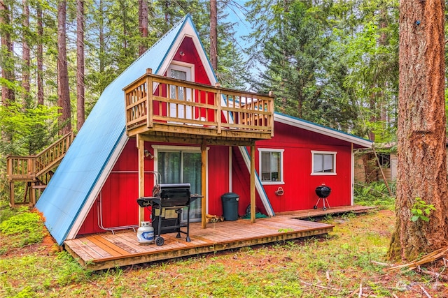 back of property featuring a deck