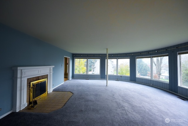 unfurnished living room featuring a brick fireplace and carpet floors