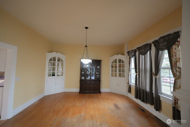 unfurnished dining area with light wood-type flooring