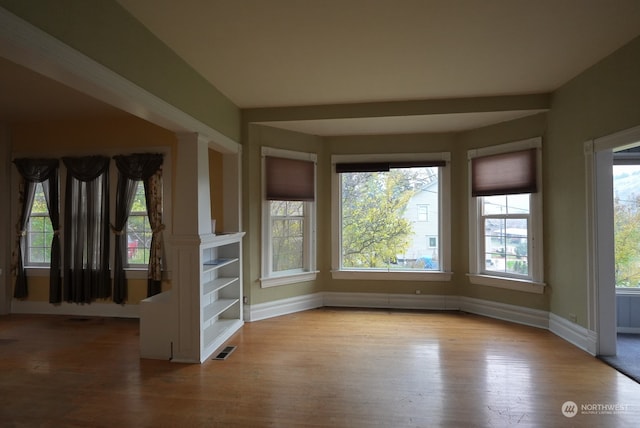 spare room featuring plenty of natural light and light hardwood / wood-style floors