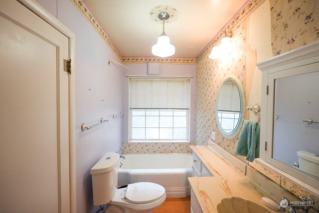 bathroom featuring toilet, a bath, and large vanity