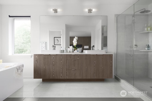 bathroom featuring a shower with door, tile flooring, and dual vanity