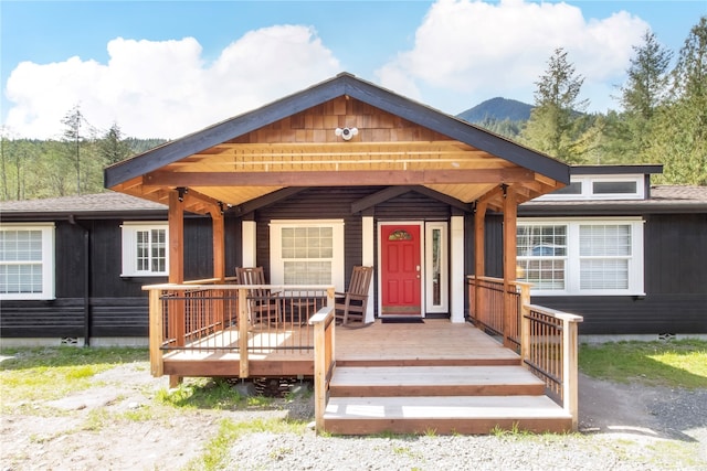 view of front of home with a mountain view and covered porch