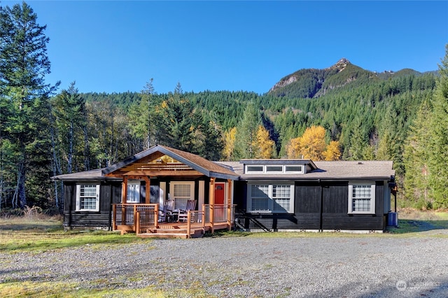 ranch-style home with a mountain view and cooling unit