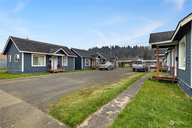 exterior space with covered porch and a front yard