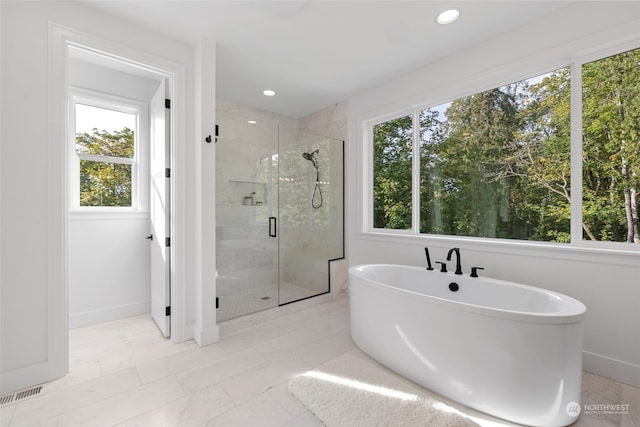 bathroom with a soaking tub, a marble finish shower, visible vents, and recessed lighting