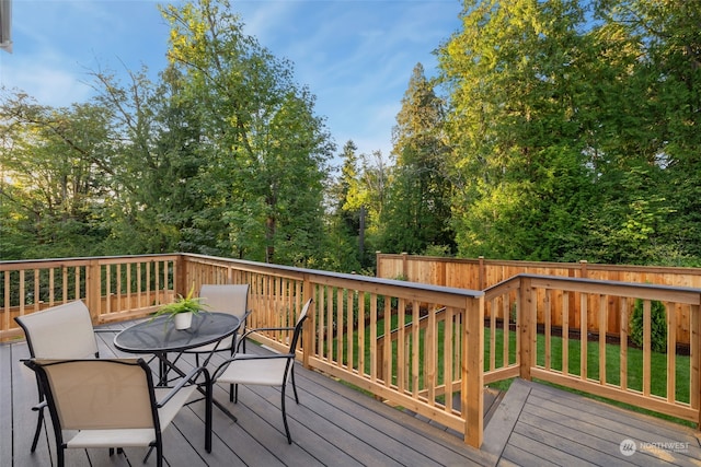 wooden terrace with fence and outdoor dining area