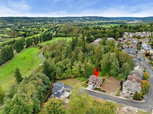 birds eye view of property with a wooded view