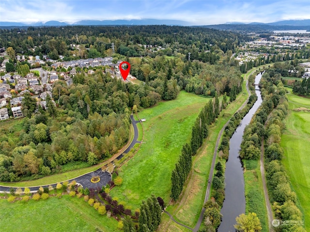 drone / aerial view with a mountain view and a forest view