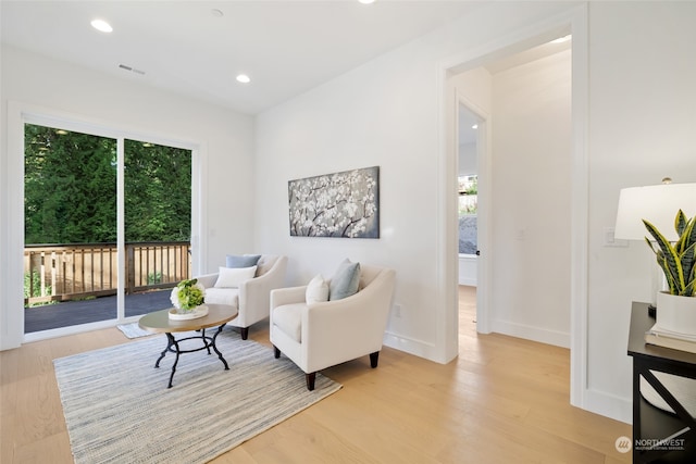 sitting room with light hardwood / wood-style flooring and plenty of natural light