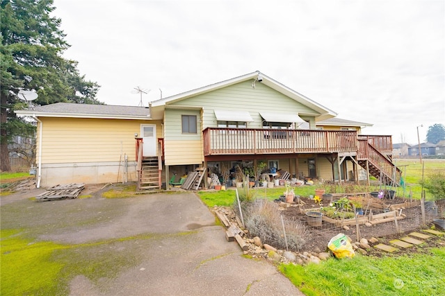 back of property featuring a wooden deck