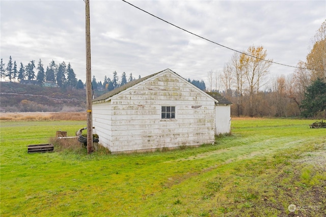 view of outbuilding with a yard