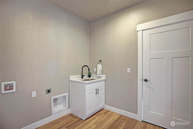 laundry area with washer hookup, electric dryer hookup, light wood-type flooring, and sink