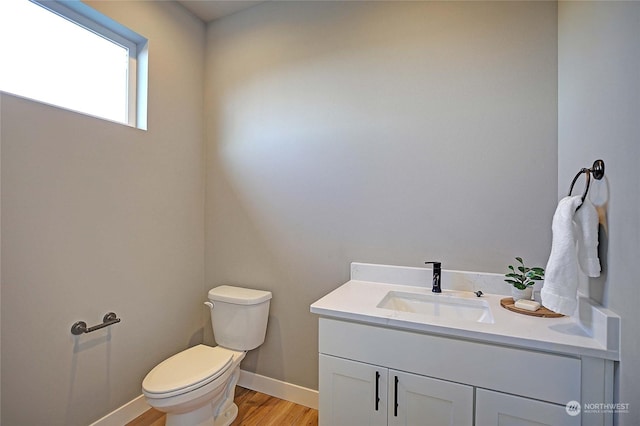 bathroom featuring hardwood / wood-style floors, vanity, and toilet