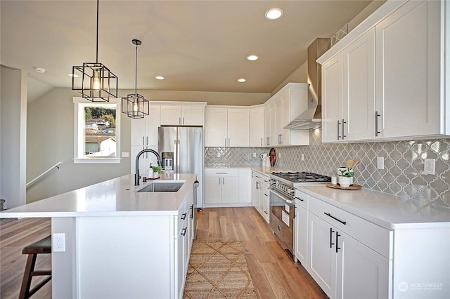 kitchen with light hardwood / wood-style floors, white cabinetry, and appliances with stainless steel finishes