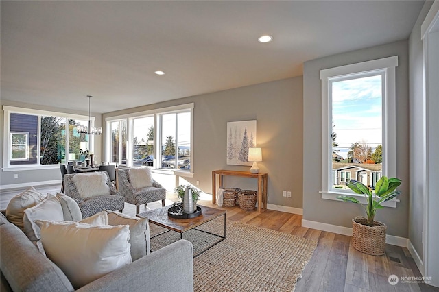 living room featuring hardwood / wood-style flooring and an inviting chandelier