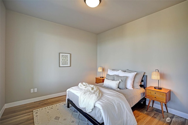 bedroom with dark wood-type flooring