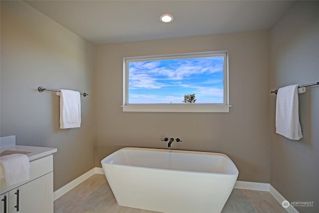 bathroom with vanity and a bath