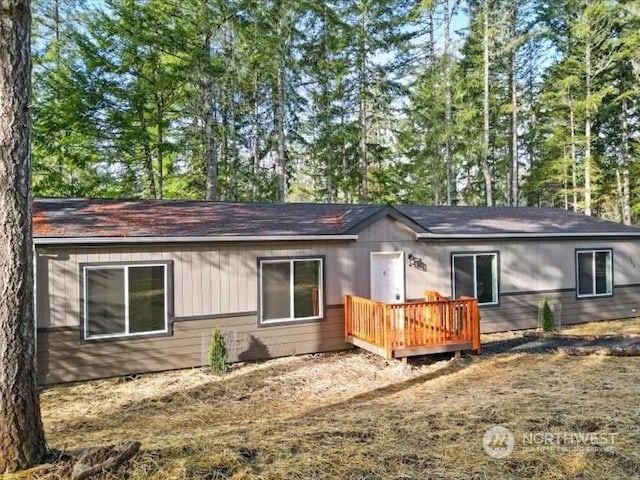 back of house featuring a wooden deck