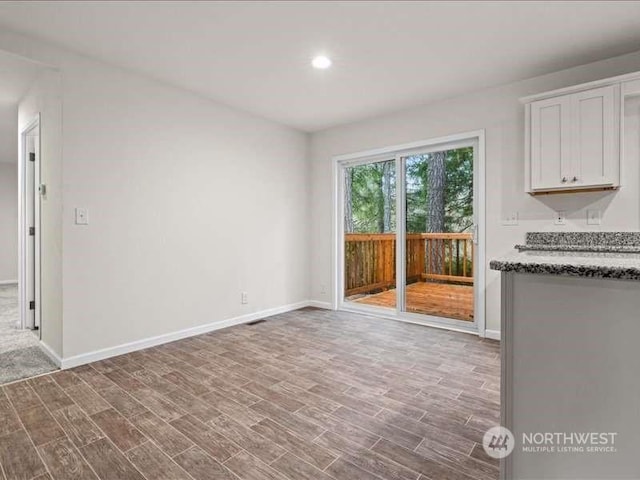 670 E Wilson Way, Grapeview, WA 98546 - unfurnished living room featuring wood finished floors, baseboards, and recessed lighting