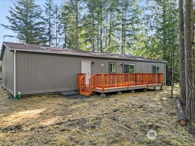 back of property featuring a wooden deck