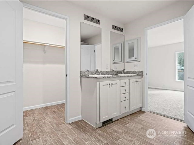 bathroom featuring double sink vanity and hardwood / wood-style flooring