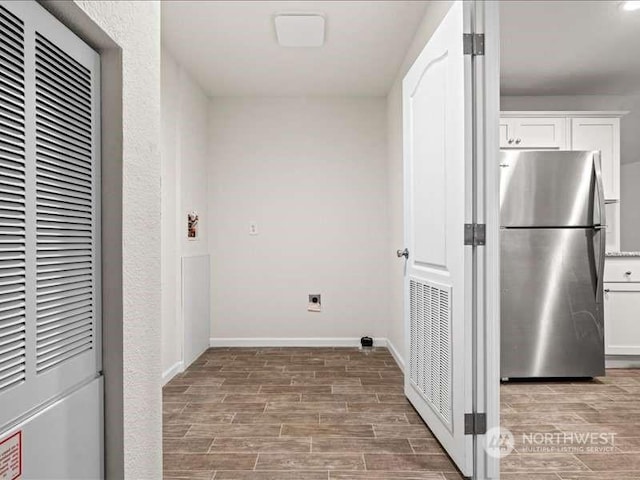 670 E Wilson Way, Grapeview, WA 98546 - laundry room featuring a heating unit, light wood finished floors, and baseboards