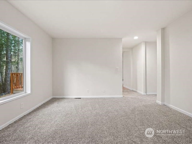 unfurnished room featuring light carpet