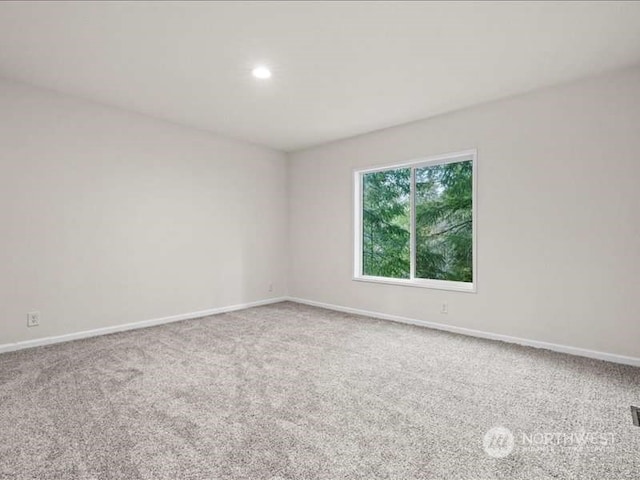 unfurnished room featuring light colored carpet