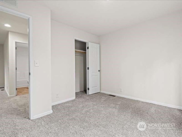 670 E Wilson Way, Grapeview, WA 98546 - unfurnished bedroom featuring carpet flooring, baseboards, and a closet