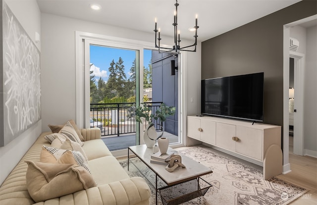 living room featuring a chandelier and light wood-type flooring