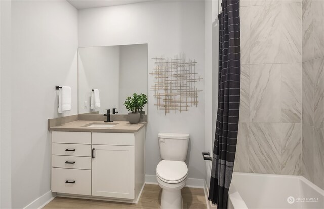 full bathroom featuring shower / tub combo with curtain, vanity, and toilet