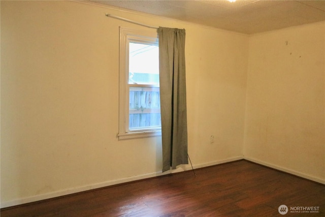 14040 Ashworth Ave N, Seattle, WA 98133 - spare room featuring ornamental molding, dark wood finished floors, baseboards, and healthy amount of natural light