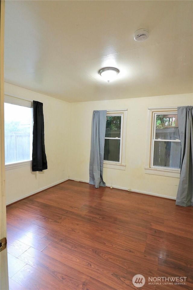 14040 Ashworth Ave N, Seattle, WA 98133 - spare room featuring wood finished floors, a smoke detector, and baseboards