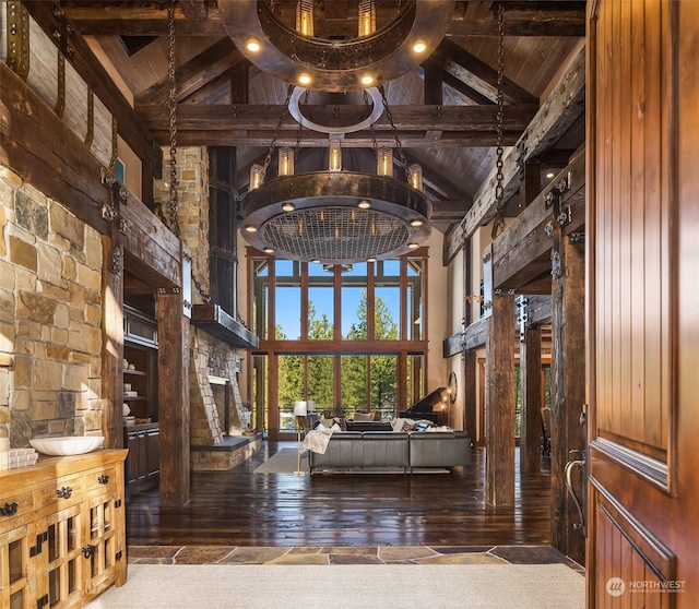 interior space featuring wood-type flooring, high vaulted ceiling, a fireplace, and wood ceiling