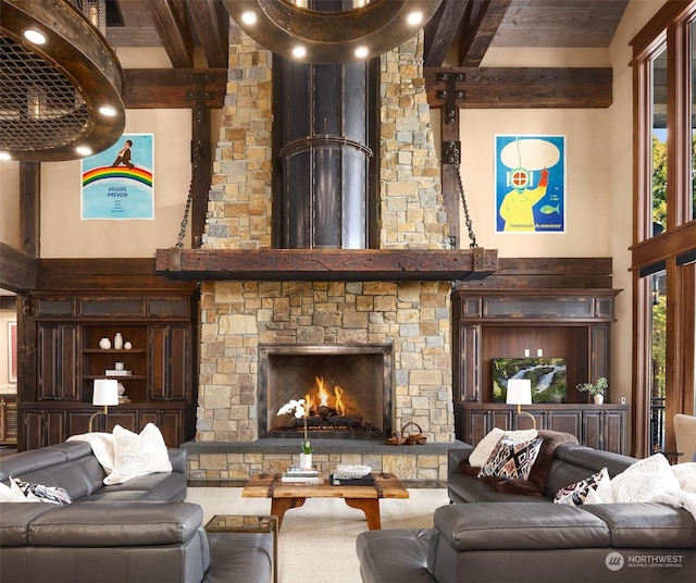 living area with beam ceiling, a towering ceiling, and a fireplace