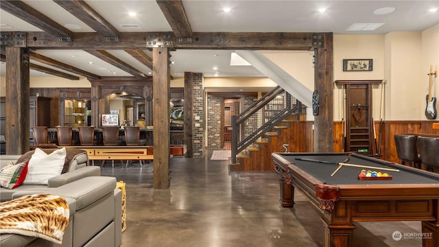 rec room featuring pool table, concrete flooring, wood walls, wainscoting, and beam ceiling