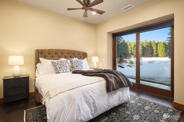 bedroom with visible vents, access to outside, and wood finished floors