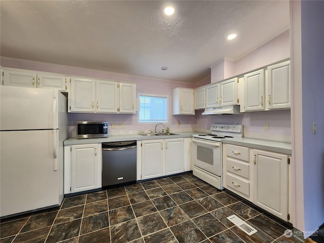 kitchen with sink, white appliances, white cabinets, and crown molding