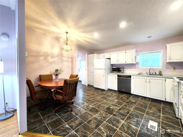 kitchen with white cabinetry, decorative light fixtures, white appliances, and sink