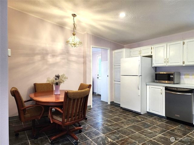 kitchen with white cabinetry, decorative light fixtures, crown molding, white fridge, and black dishwasher