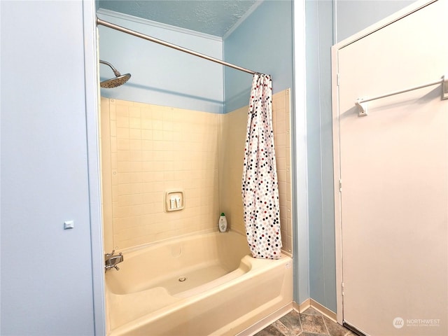 bathroom with a textured ceiling and shower / bathtub combination with curtain