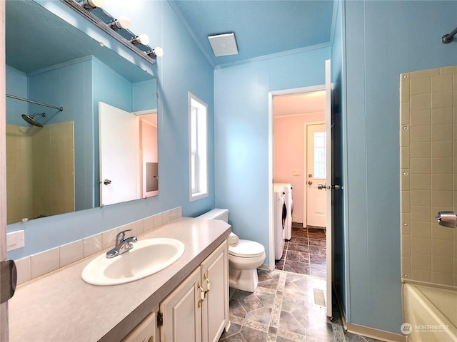 full bathroom featuring ornamental molding, vanity, separate washer and dryer, and toilet