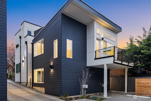 property exterior at dusk with a balcony