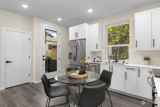 kitchen featuring white cabinetry, appliances with stainless steel finishes, dark hardwood / wood-style floors, and sink