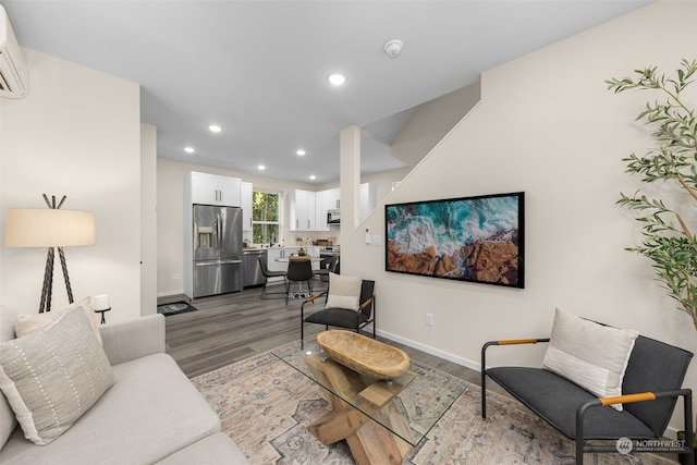 living room with hardwood / wood-style flooring and a wall mounted AC